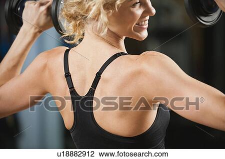 USA, California, Los Angeles, woman exercising with dumbbells View Large Photo Image Stock Image - USA, California, Los Angeles, woman exercising with dumbbells. Fotosearch