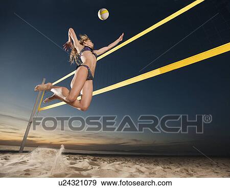 Stock Photo - USA, California, Los Angeles, woman playing beach volleyball. Fotosearch