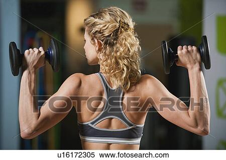 Stock Photography - USA, California, Los Angeles, woman exercising with dumbbells. Fotosearch