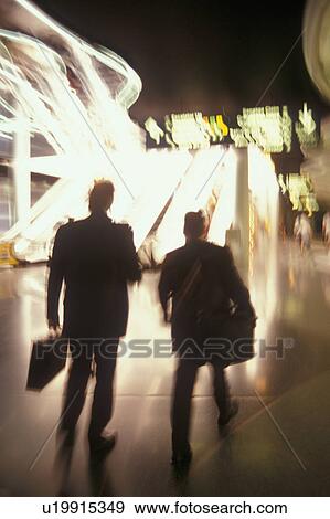 USA, Colorado, Businessmen walking through airport, blurred motion View Large Photo Image Stock Photo - USA, Colorado, Businessmen walking through airport, blurred motion. Fotosearch