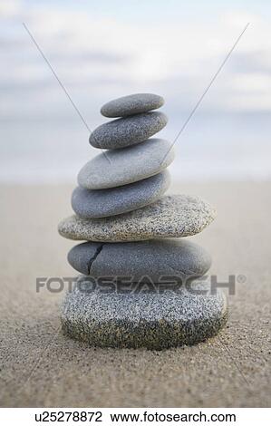 Stock Image - USA, Massachusetts, Beach stones stacked. Fotosearch