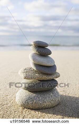 Stock Photograph - USA, Massachusetts, Beach stones stacked. Fotosearch