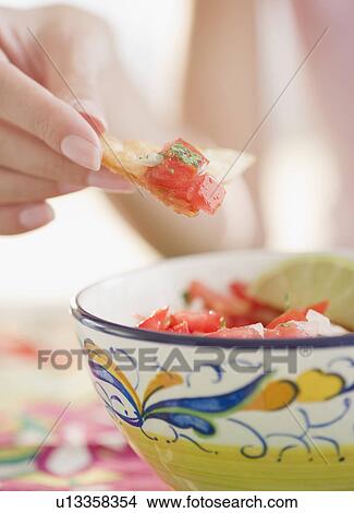 USA, New Jersey, Jersey City, Close-up view of woman's hand eating salad with cracker View Large Photo Image Picture - USA, New Jersey, Jersey City, Close-up view of woman's hand eating salad with cracker. Fotosearch