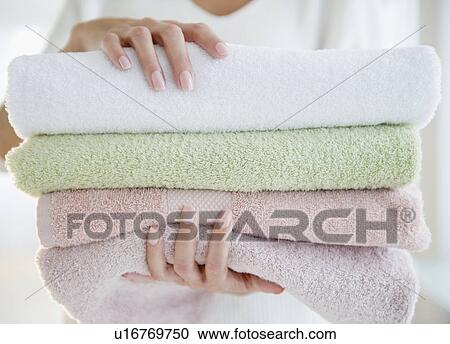 Stock Image - USA, New Jersey, Jersey City, Close-up view of woman holding fresh towels. Fotosearch