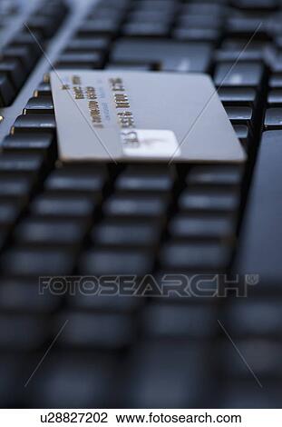 Stock Image - USA, New Jersey, Jersey City, Close-up view of computer keyboard and credit card. Fotosearch