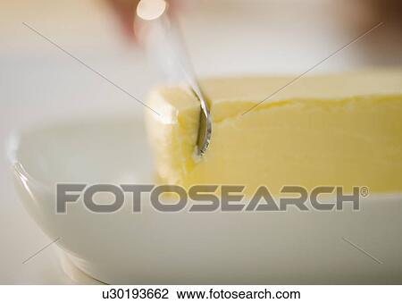 Stock Image - USA, New Jersey, Jersey City, Close-up view of knife and butter. Fotosearch