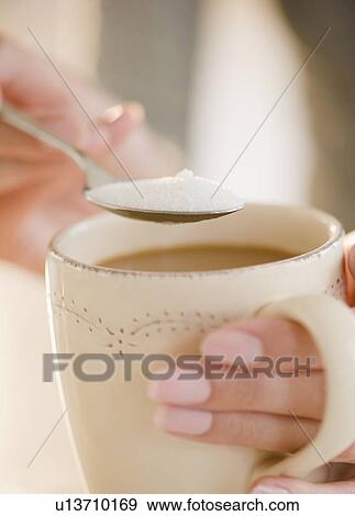 USA, New Jersey, Jersey City, Close-up view of human hand putting sugar into cup of coffee View Large Photo Image Stock Photo - USA, New Jersey, Jersey City, Close-up view of human hand putting sugar into cup of coffee. Fotosearch