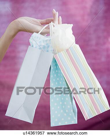 USA, New Jersey, Jersey City, Close-up view of woman's hand holding shopping bags View Large Photo Image Stock Photo - USA, New Jersey, Jersey City, Close-up view of woman's hand holding shopping bags. Fotosearch