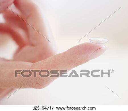 USA, New Jersey, Jersey City, Close-up view of woman hand with contact lens View Large Photo Image Stock Photo - USA, New Jersey, Jersey City, Close-up view of woman hand with contact lens. Fotosearch
