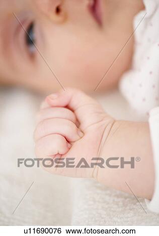 Stock Photograph - USA, New Jersey, Jersey City, Close-up view of baby girl (2-5 months). Fotosearch