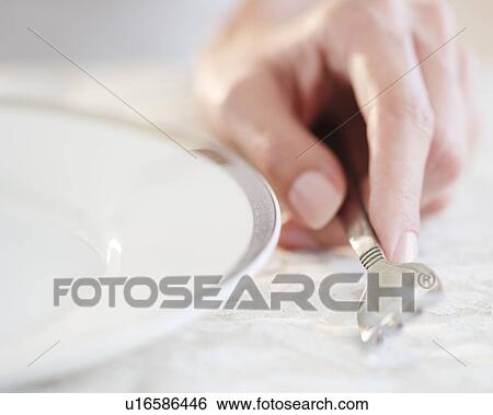 Stock Photograph - USA, New Jersey, Jersey City, Close-up view of woman's hand holding fork. Fotosearch