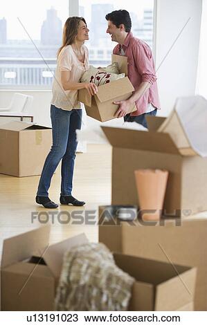 USA, New Jersey, Jersey City, Couple carrying box in new home View Large Photo Image Stock Image - USA, New Jersey, Jersey City, Couple carrying box in new home. Fotosearch