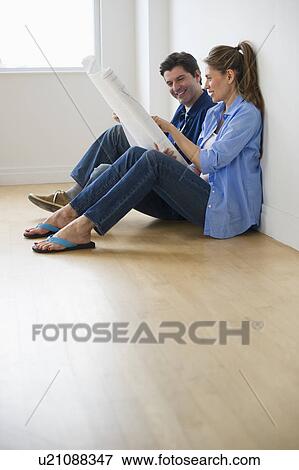 USA, New Jersey, Jersey City, Couple examining blueprints in new home View Large Photo Image Stock Photo - USA, New Jersey, Jersey City, Couple examining blueprints in new home . Fotosearch