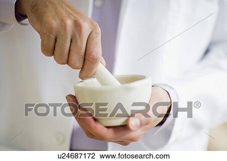 USA, New Jersey, Jersey City, Doctor preparing medicine using mortar and pestle View Large Photo Image Stock Image - USA, New Jersey, Jersey City, Doctor preparing medicine using mortar and pestle. Fotosearch