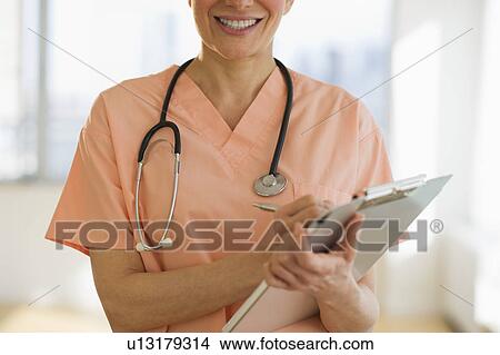 USA, New Jersey, Jersey City, Female doctor writing medical report View Large Photo Image Picture - USA, New Jersey, Jersey City, Female doctor writing medical report. Fotosearch