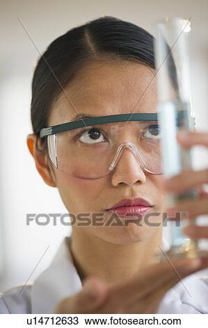 USA, New Jersey, Jersey City, Female scientist holding chemical test tube View Large Photo Image Stock Image - USA, New Jersey, Jersey City, Female scientist holding chemical test tube. Fotosearch