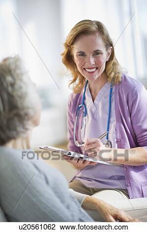 Stock Image - USA, New Jersey, Jersey City, Female nurse with patient. Fotosearch