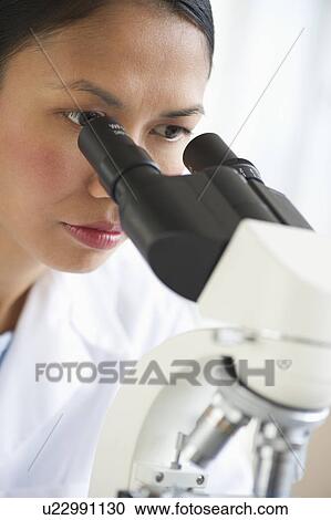 USA, New Jersey, Jersey City, Female scientist using microscope View Large Photo Image Stock Image - USA, New Jersey, Jersey City, Female scientist using microscope. Fotosearch