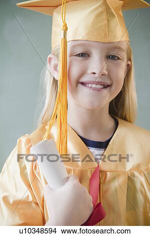 USA, New Jersey, Jersey City, Girl (8-9) wearing yellow mortar board and graduation gown View Large Photo Image Picture - USA, New Jersey, Jersey City, Girl (8-9) wearing yellow mortar board and graduation gown. Fotosearch