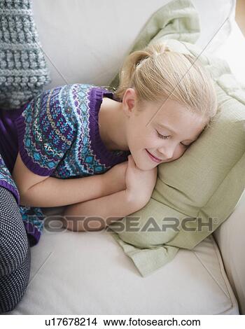USA, New Jersey, Jersey City, Girl (8-9) sleeping on sofa View Large Photo Image Picture - USA, New Jersey, Jersey City, Girl (8-9) sleeping on sofa. Fotosearch