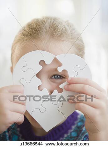 USA, New Jersey, Jersey City, Girl (8-9) holding puzzle heart View Large Photo Image Picture - USA, New Jersey, Jersey City, Girl (8-9) holding puzzle heart. Fotosearch