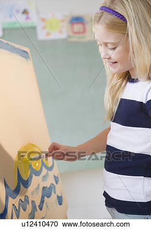 Stock Image - USA, New Jersey, Jersey City, Girl (8-9) painting. Fotosearch