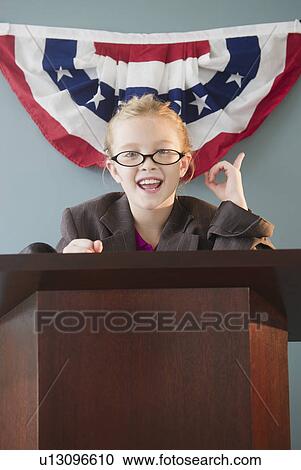 Stock Image - USA, New Jersey, Jersey City, Girl (8-9) giving speech from pulpit. Fotosearch