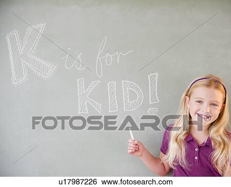 Stock Photograph - USA, New Jersey, Jersey City, Girl (8-9) writing on blackboard. Fotosearch