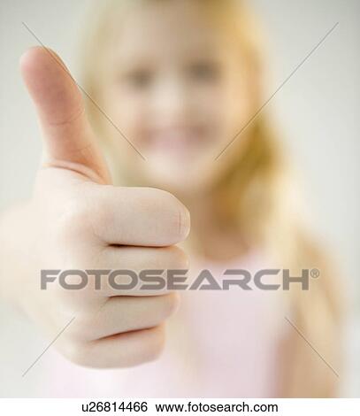 Stock Photograph - USA, New Jersey, Jersey City, Girl (8-9) with thumb-up. Fotosearch