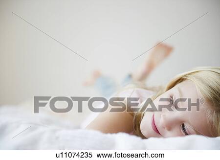 USA, New Jersey, Jersey City, Girl (8-9) laying in bed View Large Photo Image Stock Photography - USA, New Jersey, Jersey City, Girl (8-9) laying in bed. Fotosearch