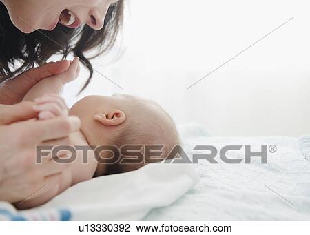 USA, New Jersey, Jersey City, Mother laughing over baby girl (2-5 months) View Large Photo Image Stock Image - USA, New Jersey, Jersey City, Mother laughing over baby girl (2-5 months). Fotosearch