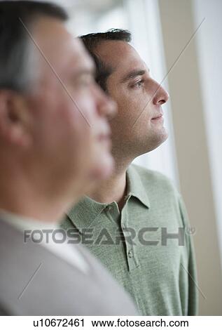 Stock Image - USA, New Jersey, Jersey City, Pensive man with father in foreground. Fotosearch