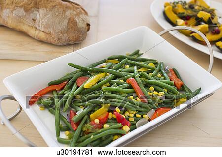 Stock Image - USA, New Jersey, Jersey City, Plate of cooked vegetables on table. Fotosearch