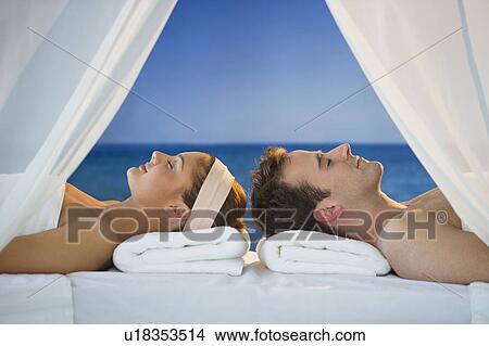USA, New Jersey, Jersey City, Portrait of young couple lying in spa View Large Photo Image Picture - USA, New Jersey, Jersey City, Portrait of young couple lying in spa . Fotosearch