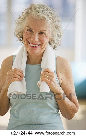 Picture - USA, New Jersey, Jersey City, Portrait of senior woman with towel at gym. Fotosearch