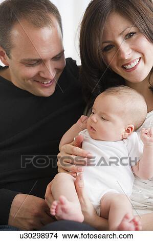 USA, New Jersey, Jersey City, Portrait of family with baby girl (2-5 months) View Large Photo Image Picture - USA, New Jersey, Jersey City, Portrait of family with baby girl (2-5 months). Fotosearch