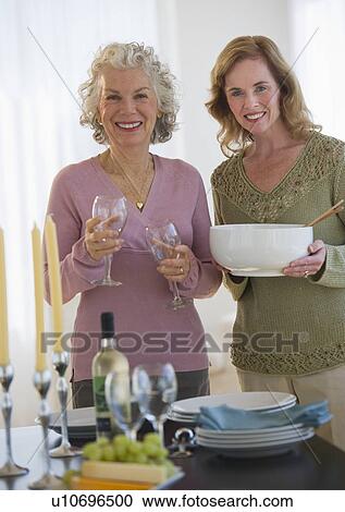 USA, New Jersey, Jersey City, Portrait of mother and daughter setting table in home View Large Photo Image Stock Image - USA, New Jersey, Jersey City, Portrait of mother and daughter setting table in home. Fotosearch