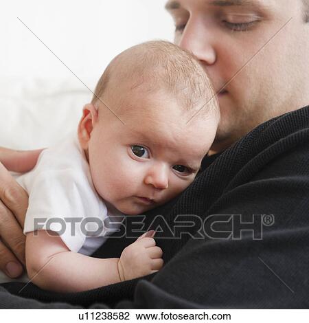 Stock Image - USA, New Jersey, Jersey City, Portrait of father and baby daughter (2-5 months). Fotosearch