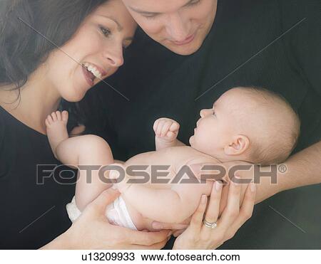 USA, New Jersey, Jersey City, Portrait of family with baby girl (2-5 months) View Large Photo Image Stock Image - USA, New Jersey, Jersey City, Portrait of family with baby girl (2-5 months). Fotosearch