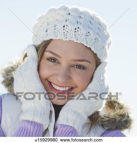 USA, New Jersey, Jersey City, Portrait of young woman wearing white knitted hat View Large Photo Image Stock Image - USA, New Jersey, Jersey City, Portrait of young woman wearing white knitted hat. Fotosearch