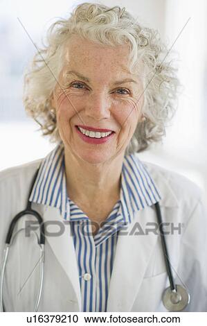 Stock Image - USA, New Jersey, Jersey City, Portrait of senior female doctor with stethoscope. Fotosearch