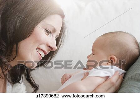Stock Image - USA, New Jersey, Jersey City, Portrait of mother and baby daughter (2-5 months). Fotosearch
