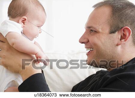 Stock Image - USA, New Jersey, Jersey City, Portrait of father and baby daughter (2-5 months). Fotosearch