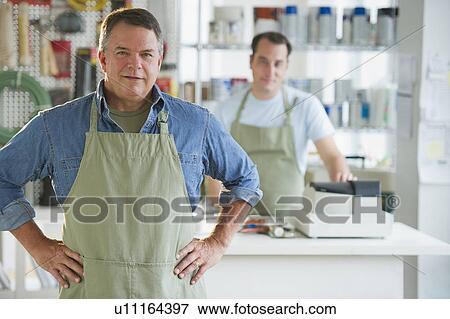 Stock Photo - USA, New Jersey, Jersey City, Portrait of hardware shop owner and assistant. Fotosearch