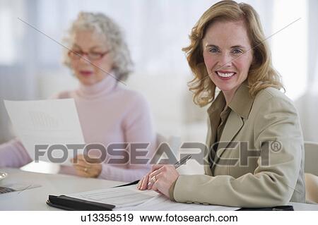 USA, New Jersey, Jersey City, Portrait of financial advisor with senior woman in home View Large Photo Image Stock Photo - USA, New Jersey, Jersey City, Portrait of financial advisor with senior woman in home. Fotosearch