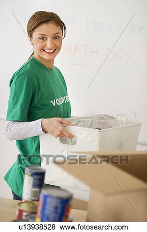 USA, New Jersey, Jersey City, Portrait of young woman as volunteer View Large Photo Image Stock Photo - USA, New Jersey, Jersey City, Portrait of young woman as volunteer. Fotosearch