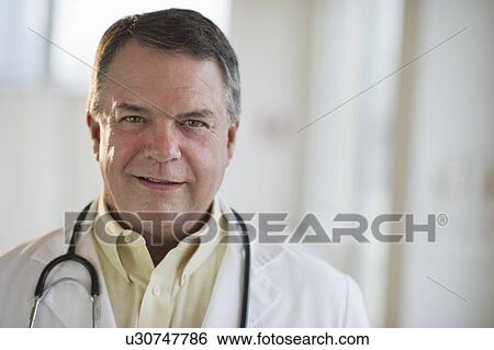 Stock Photograph - USA, New Jersey, Jersey City, Portrait of doctor with stethoscope. Fotosearch