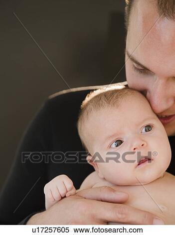 Stock Photography - USA, New Jersey, Jersey City, Portrait of father and baby daughter (2-5 months). Fotosearch