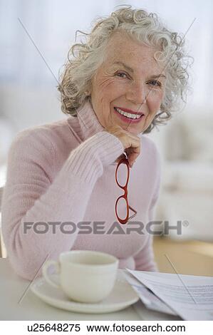USA, New Jersey, Jersey City, Portrait of senior woman holding glasses View Large Photo Image Stock Photography - USA, New Jersey, Jersey City, Portrait of senior woman holding glasses. Fotosearch