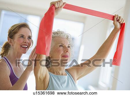 USA, New Jersey, Jersey City, Senior woman with fitness instructor at gym View Large Photo Image Stock Photo - USA, New Jersey, Jersey City, Senior woman with fitness instructor at gym. Fotosearch